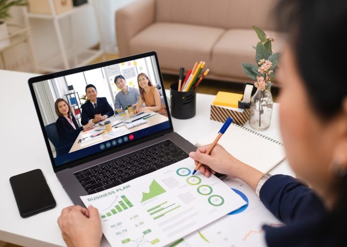 Video conference meeting from home.asian woman present business chart project on teleconference collaboration with colleagues with laptop at home.banner space for display of content